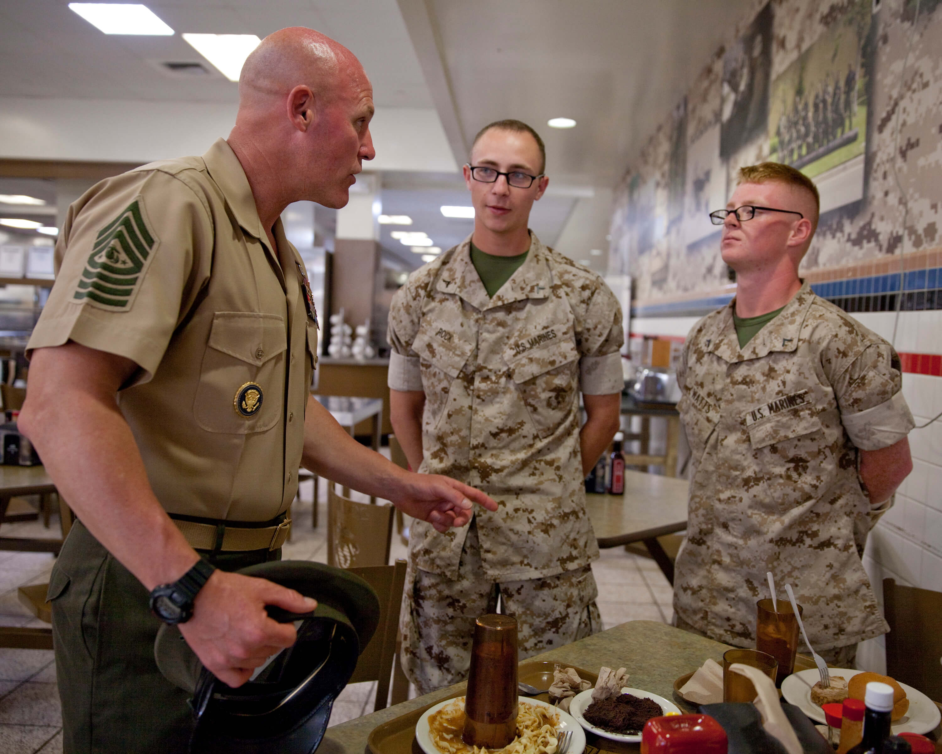 Micheal P. Barrett, the 17th Sergeant Major of the Marine Corps, talks with...